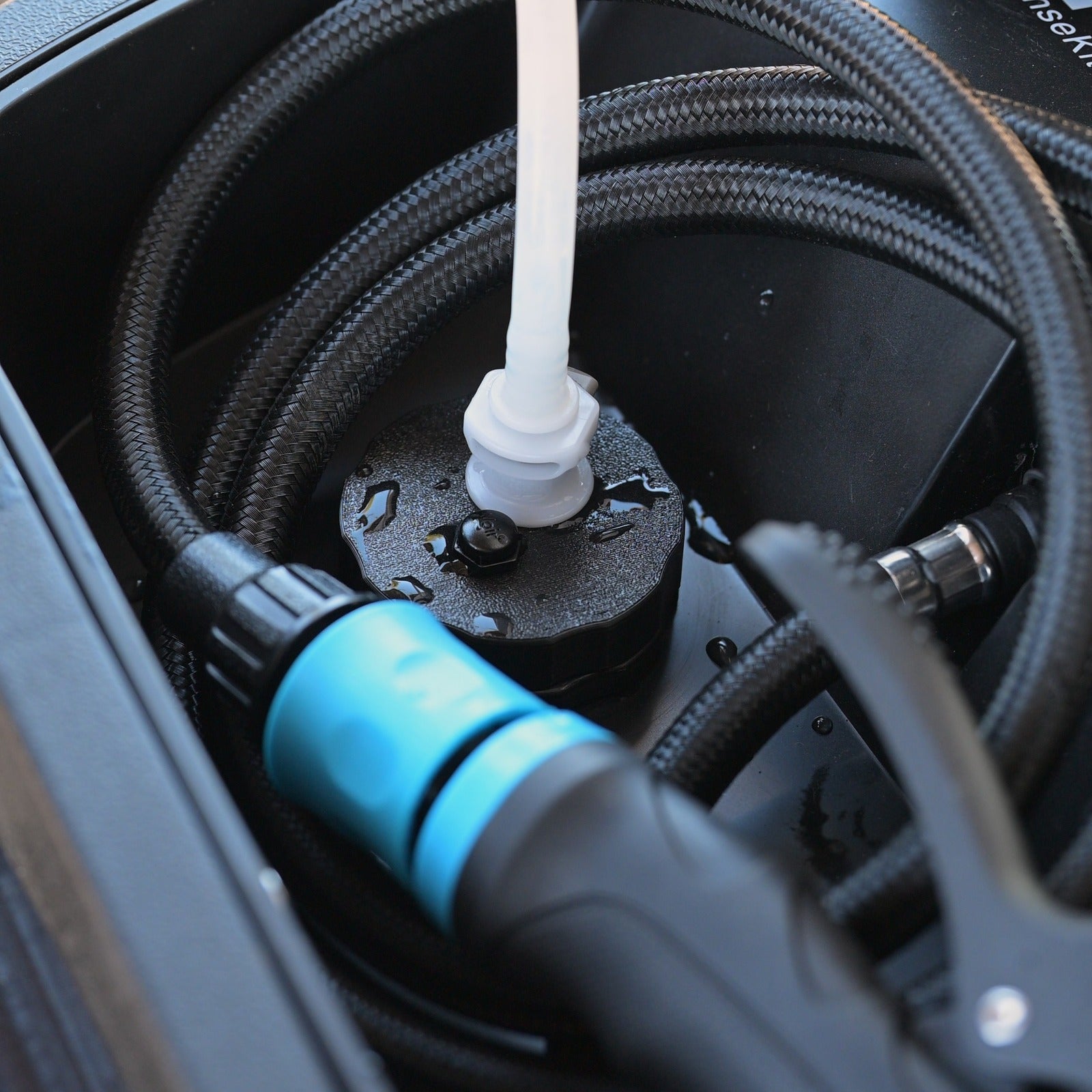 Pacific Peak Overland faucet adapter cap installed on a RinseKit Pro, showing the breather vent, quick-connect fitting and food-grade pickup tube